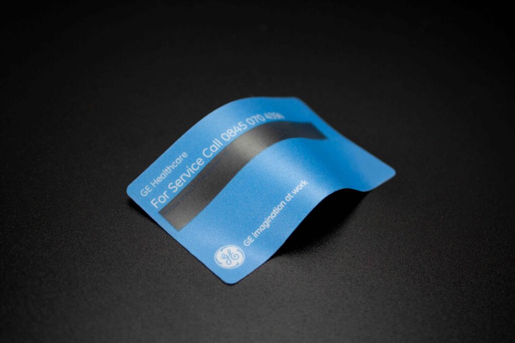 Light blue healthcare plastic label with white writing and clear window